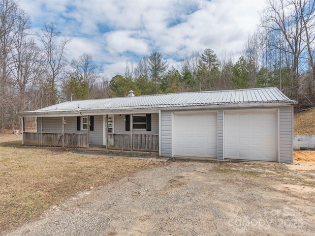 ranch-style house with a garage and covered porch