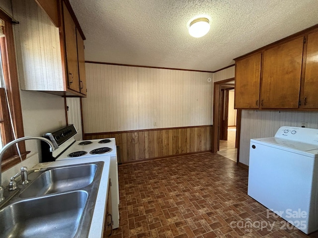 kitchen with white electric range, washer / dryer, sink, crown molding, and a textured ceiling