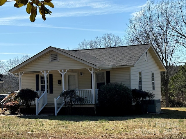 view of front of house featuring a porch, central AC, and a front lawn