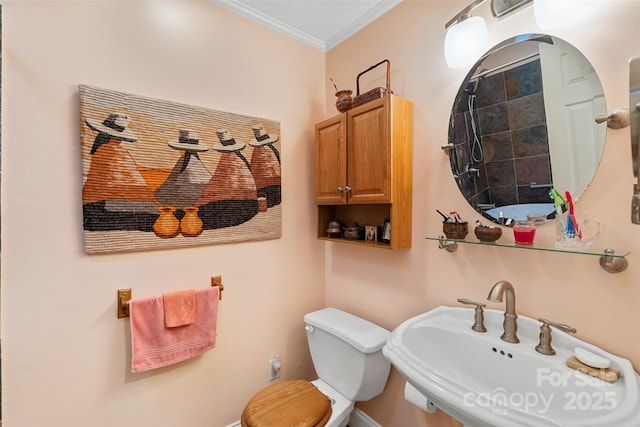 bathroom featuring ornamental molding, sink, and toilet