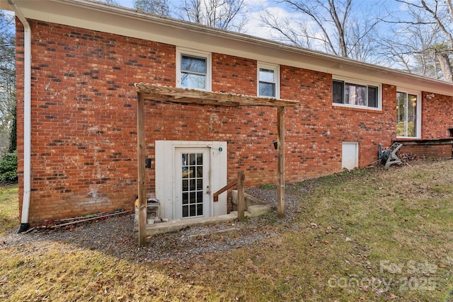 rear view of property featuring a lawn