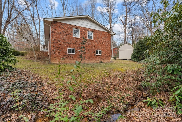 view of home's exterior featuring a lawn and a storage shed