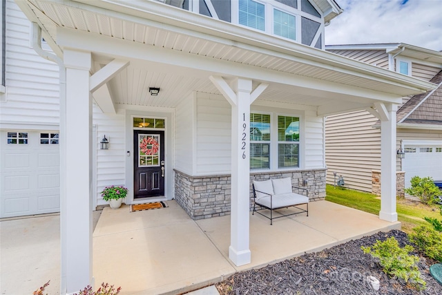 entrance to property with a garage and covered porch