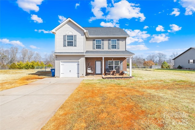 view of front of home featuring a garage, a front lawn, and covered porch