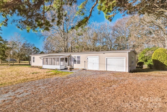 view of front facade with a front lawn and a sunroom