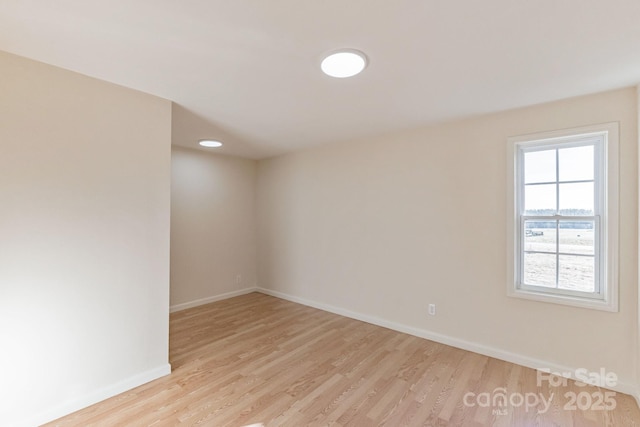 unfurnished room featuring light hardwood / wood-style floors