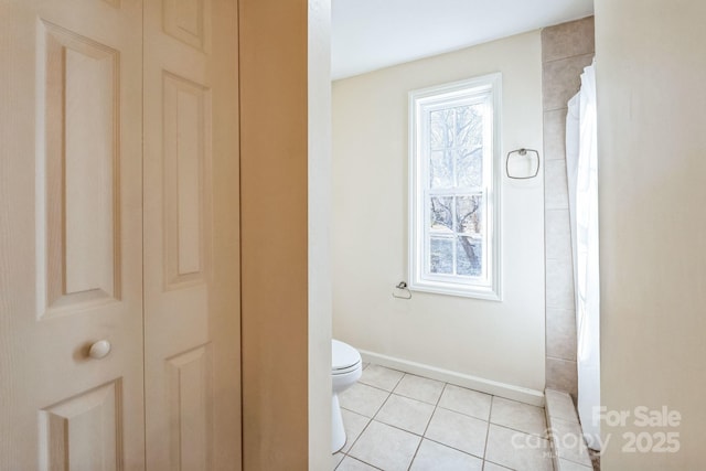 bathroom featuring walk in shower, toilet, and tile patterned flooring