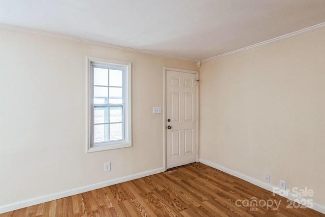 interior space with ornamental molding and hardwood / wood-style floors