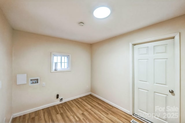 washroom featuring washer hookup and light hardwood / wood-style floors