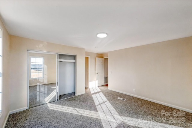 unfurnished bedroom with carpet and a closet