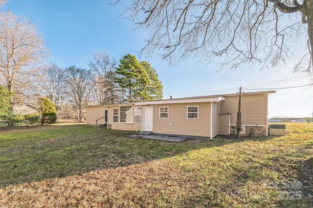 back of property featuring a lawn