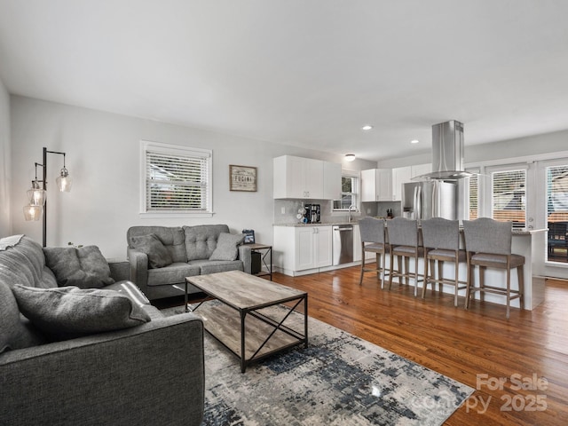 living room with wood finished floors and recessed lighting