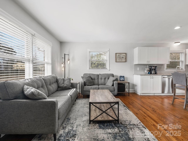 living area featuring wood finished floors and recessed lighting