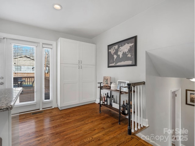 entryway with dark wood-style flooring, visible vents, and recessed lighting