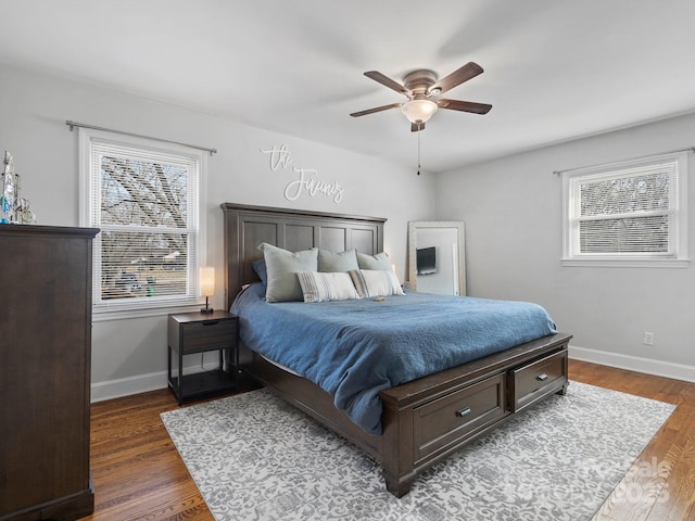 bedroom featuring dark wood-type flooring, a ceiling fan, and baseboards