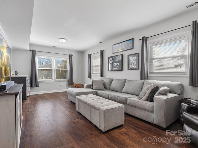 living area featuring dark wood-style floors, visible vents, and baseboards