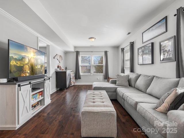 living area with visible vents, baseboards, and dark wood finished floors