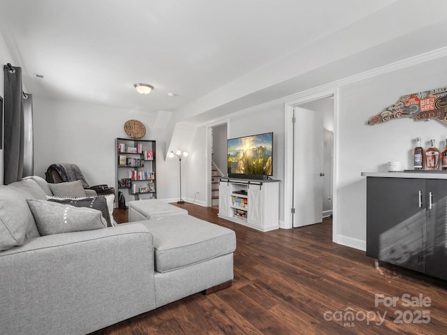 living room featuring dark wood-style floors, baseboards, and stairway