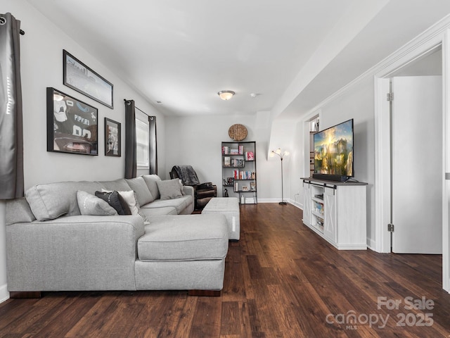 living room featuring baseboards and dark wood-style flooring