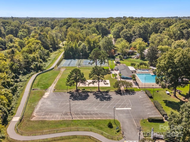 bird's eye view with a wooded view