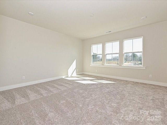 carpeted spare room with plenty of natural light