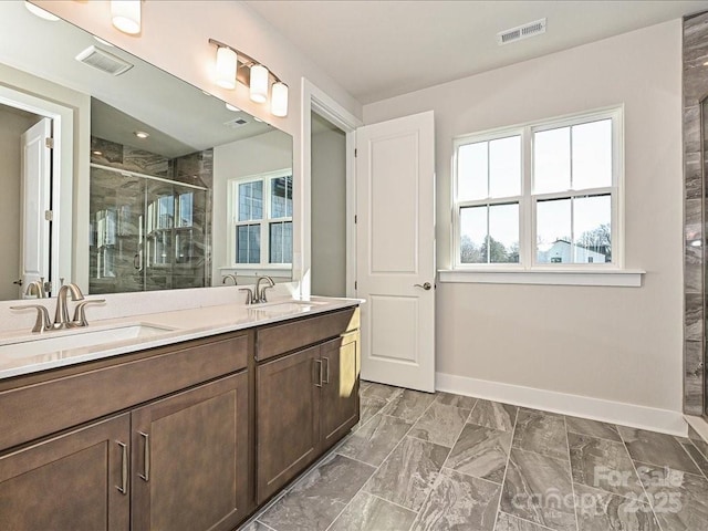 bathroom featuring vanity and a shower with shower door