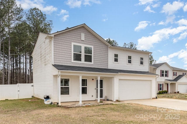 traditional home featuring a porch, a front yard, a gate, fence, and driveway