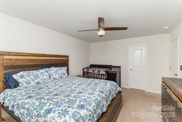 bedroom featuring ceiling fan, baseboards, and light colored carpet