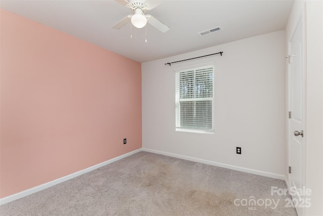 empty room with visible vents, ceiling fan, light carpet, and baseboards
