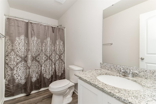 bathroom featuring a shower with curtain, vanity, toilet, and wood finished floors