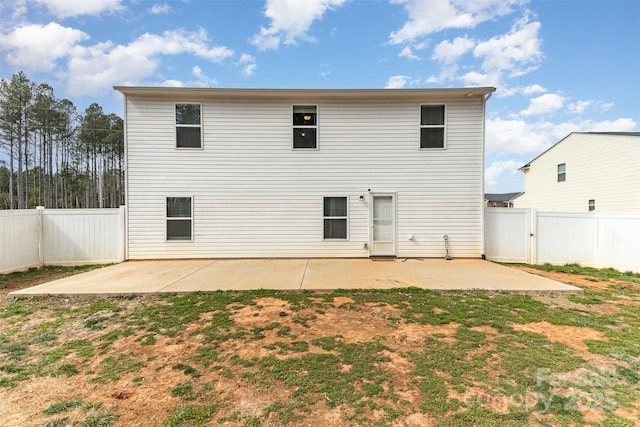 back of house featuring a patio area, a fenced backyard, and a lawn