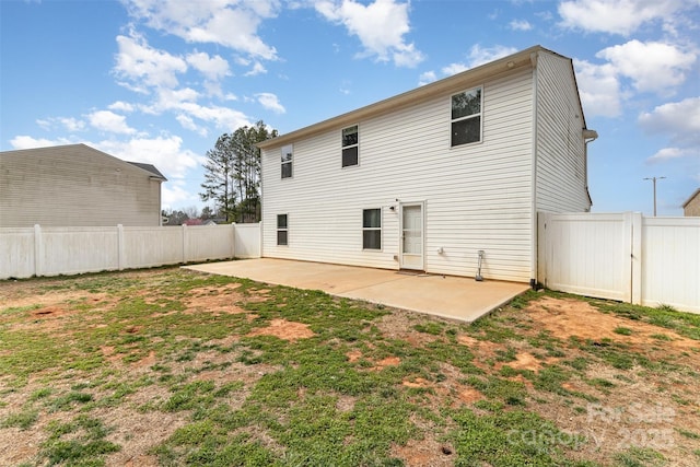 rear view of house featuring a patio area, a lawn, and a fenced backyard