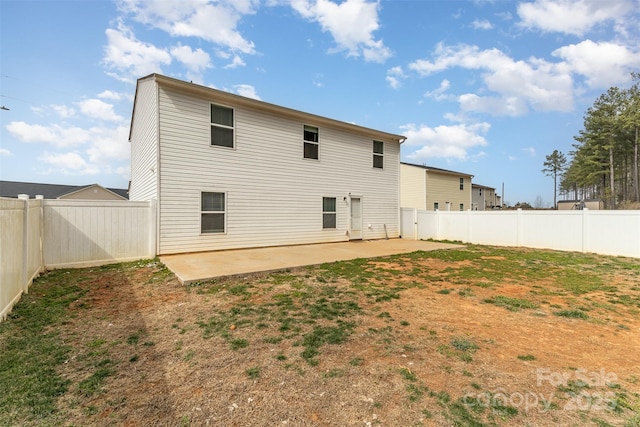 back of house featuring a patio and a fenced backyard