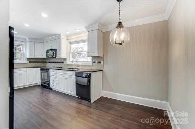 kitchen featuring sink, black appliances, dark hardwood / wood-style floors, pendant lighting, and white cabinets