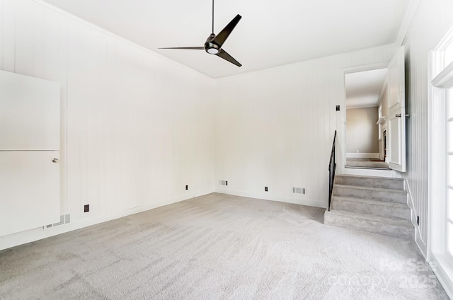 interior space featuring ceiling fan and light colored carpet