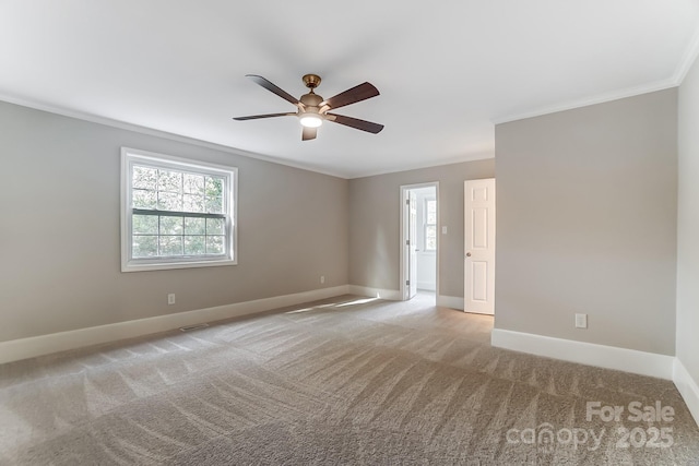 carpeted empty room with ornamental molding and ceiling fan