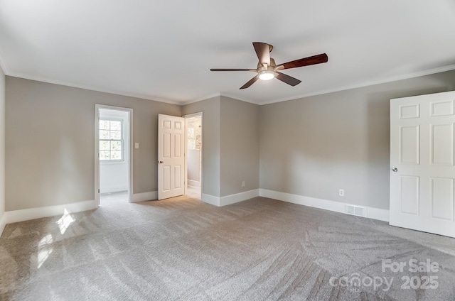 carpeted empty room featuring ornamental molding and ceiling fan