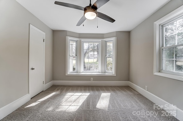 spare room with carpet floors and ceiling fan