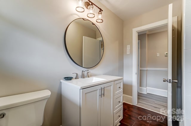 bathroom featuring vanity, hardwood / wood-style flooring, and toilet