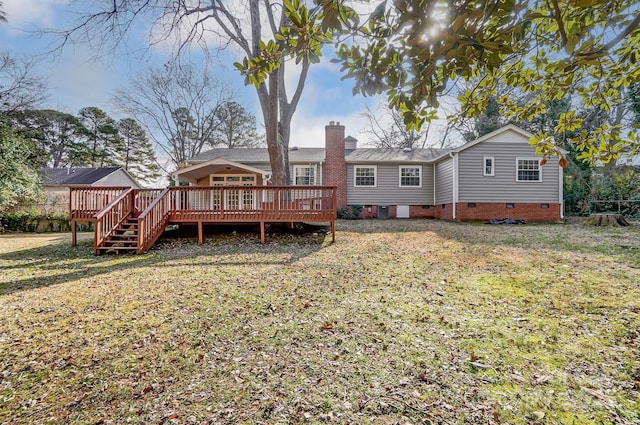 back of house with cooling unit, a deck, and a lawn