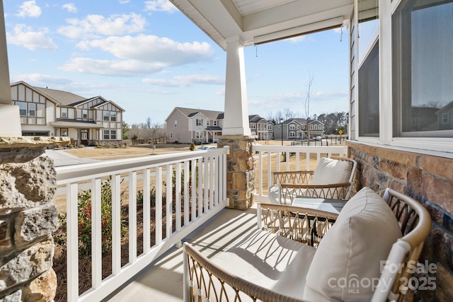 balcony with a residential view and a porch