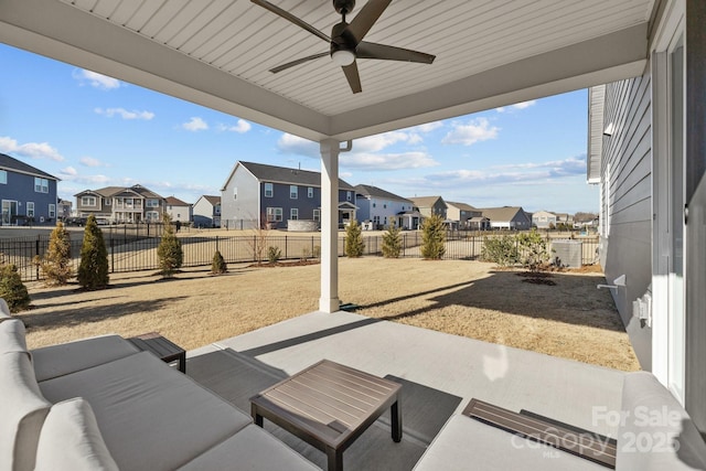 view of patio with a fenced backyard, a residential view, and a ceiling fan