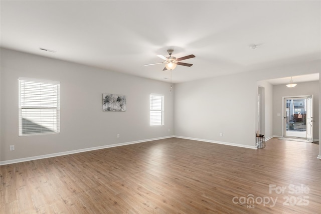 spare room featuring dark wood-type flooring and ceiling fan