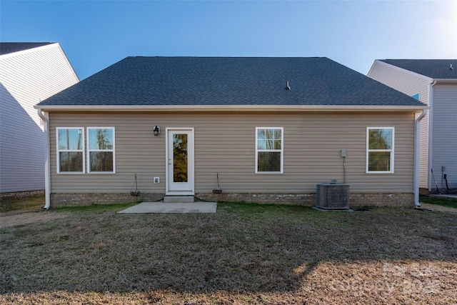 rear view of property with a yard, a patio, and central air condition unit