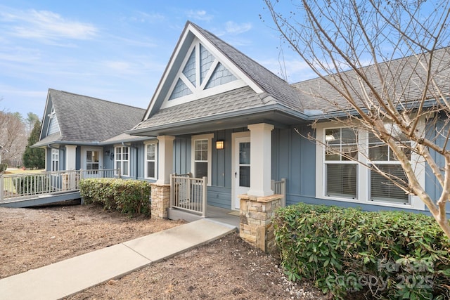 view of front of property featuring board and batten siding, a shingled roof, and a porch