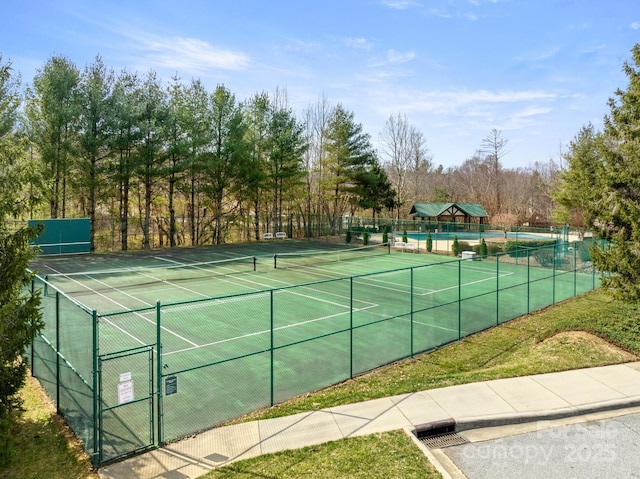 view of sport court featuring a gate and fence