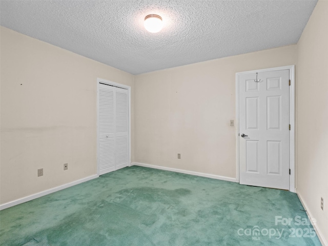416 Hunters Glen Ln, Hendersonville, NC 28739 - unfurnished bedroom featuring baseboards, carpet, a closet, and a textured ceiling