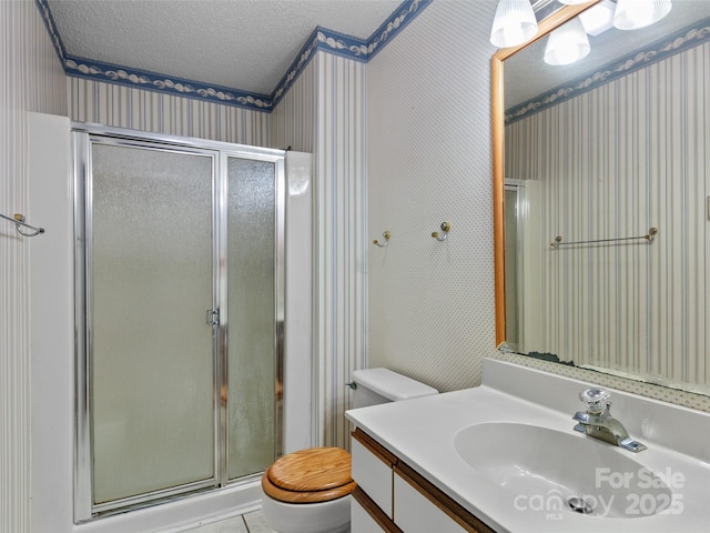 416 Hunters Glen Ln, Hendersonville, NC 28739 - full bath with vanity, toilet, a textured ceiling, wallpapered walls, and a stall shower