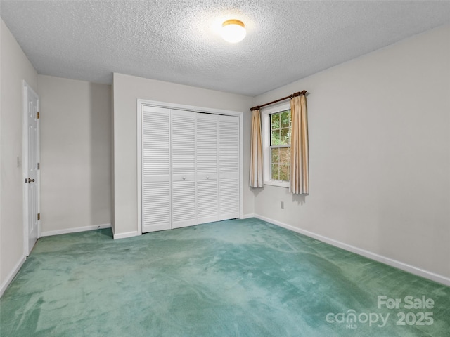416 Hunters Glen Ln, Hendersonville, NC 28739 - unfurnished bedroom with a closet, a textured ceiling, carpet, and baseboards