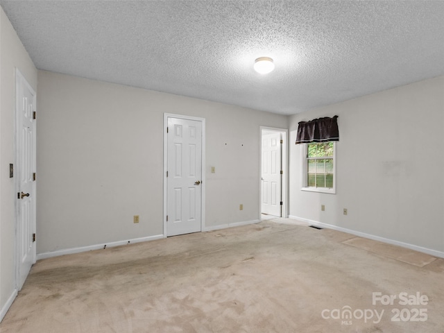 416 Hunters Glen Ln, Hendersonville, NC 28739 - carpeted spare room featuring a textured ceiling, visible vents, and baseboards